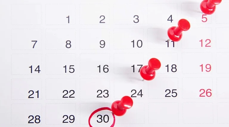 Como travar o patrimônio do devedor: Calendário com alfinetes marcando prazos processuais para averbação e comunicação