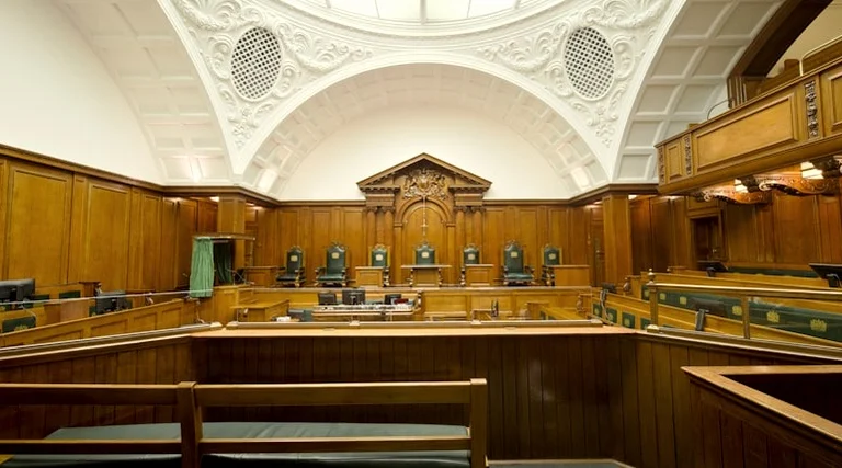 ITBI cobrado a mais na compra do imóvel: ITBI cobrado ITBI cobrado a mais na compra do imóvel: Plenário de tribunal superior com bancadas em madeira e cadeiras vazias ilustrando